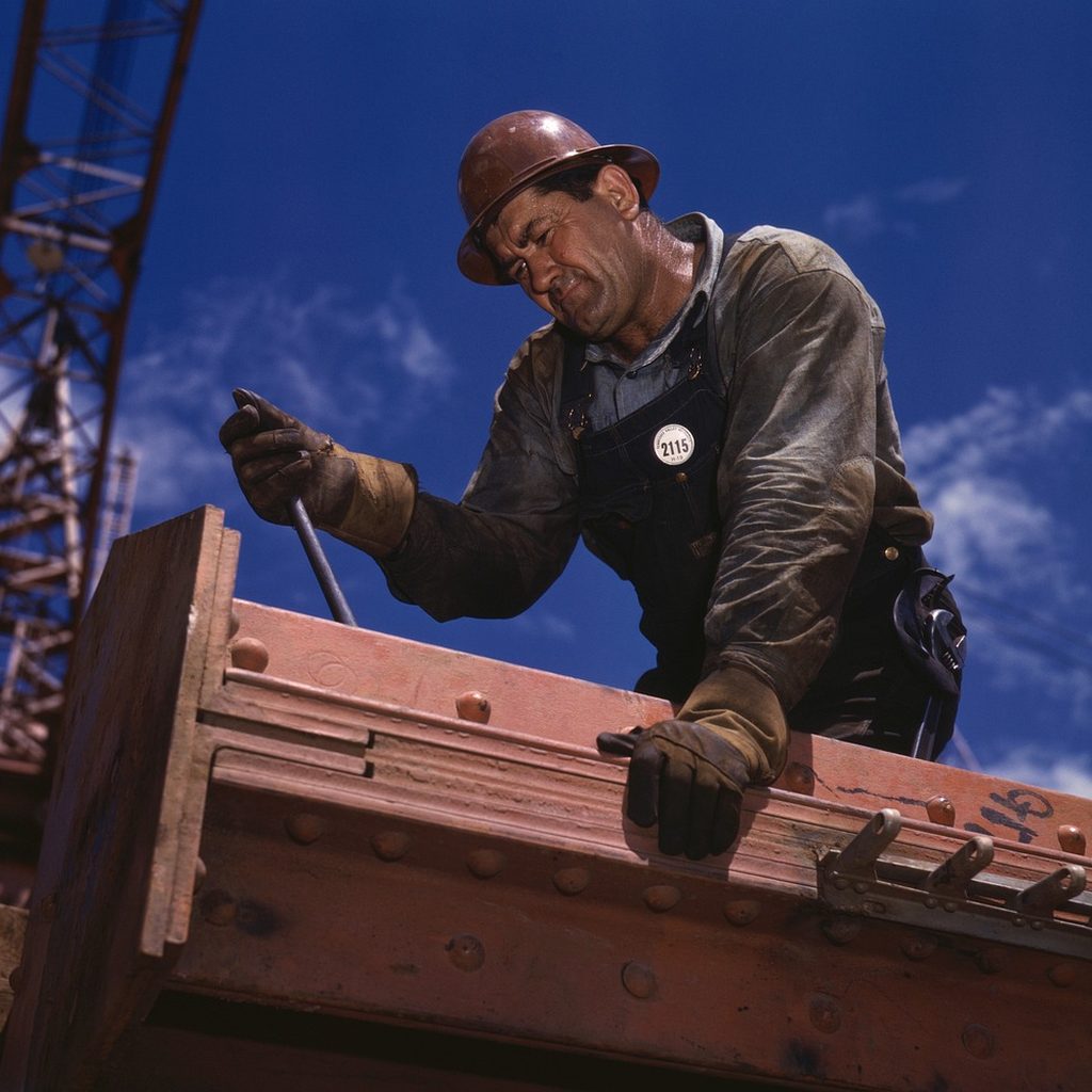 Professional mechanic performing precision automotive work in a well-equipped service bay